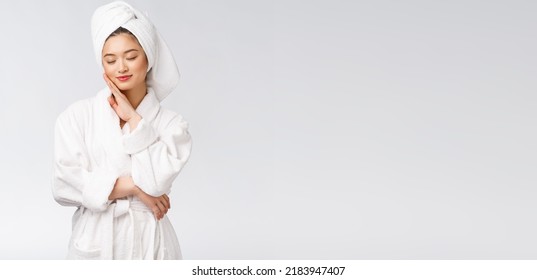 Portrait Of A Young Happy Asian Lady In Bathrobe.Isolated In White Background.