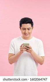 Portrait Of Young Happy Asian Man Using Phone