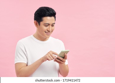 Portrait Of Young Happy Asian Man Using Phone