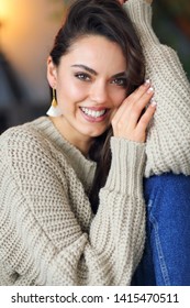 Portrait of a young happy beautiful brunette woman in warm clothings at home  - Shutterstock ID 1415470511