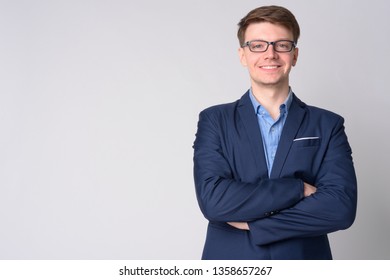 Portrait of young happy businessman with eyeglasses crossing arms - Shutterstock ID 1358657267