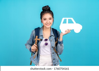 Portrait Of Young Happy Carefree Asian Woman Holding White Paper Car In Concept Of Back To Domestic Travel, Travel Bubble, Insurance Service Care Or Protection, Auto Finance, Secure Cover Or Coverage.