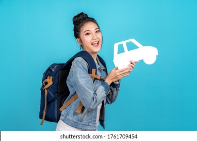 Portrait Of Young Happy Carefree Asian Woman Holding White Paper Car In Concept Of Back To Domestic Travel, Travel Bubble, Insurance Service Care Or Protection, Auto Finance, Secure Cover Or Coverage.