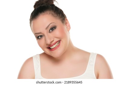 Portrait Of A Young Happy Chubby Woman With Makeup On A White Background.