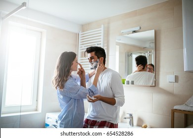 Portrait of young happy couple getting ready together in the bathroom. - Powered by Shutterstock