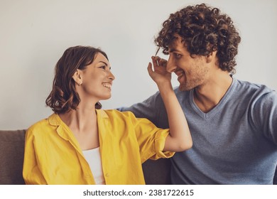 Portrait of young happy couple in love. Woman is playing with man's curly hair. - Powered by Shutterstock