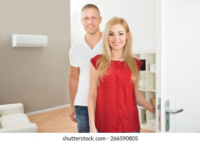 Portrait Of Young Happy Couple In New Home