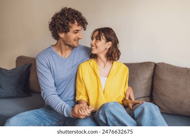 Portrait of young happy couple who is holding hands and smiling. - Powered by Shutterstock