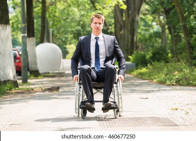 Portrait Of Young Happy Disabled Man On Wheelchair