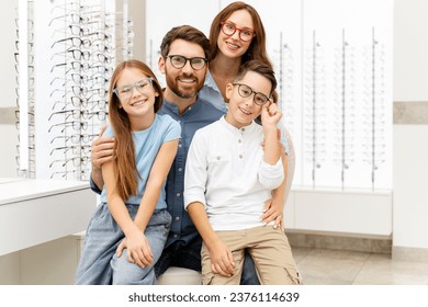 Portrait of young happy family wearing stylish eyeglasses sitting in  optical store. Vision concept 