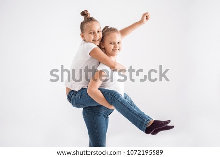 Similar – Image, Stock Photo Sisters enjoying piggyback ride