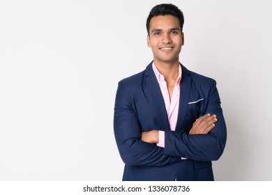 Portrait Of Young Happy Indian Businessman In Suit Smiling With Arms Crossed