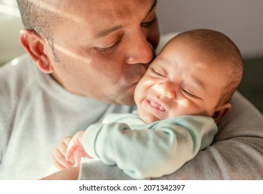 Portrait Of Young Happy Latin Hispanic Father With His Newborn Baby. Family, Fatherhood And People Concept . 