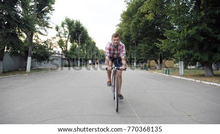 Similar – Image, Stock Photo Two men having fun riding bike and skateboard