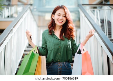 Portrait Of Young Happy Smiling Asia Woman With Shopping Bags