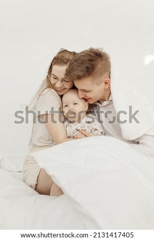 Similar – Relaxed mother and sons playing over the bed