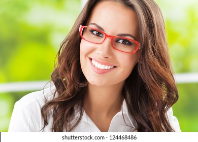 Portrait Of Young Happy Smiling Cheerful Business Woman In Glasses, At Office