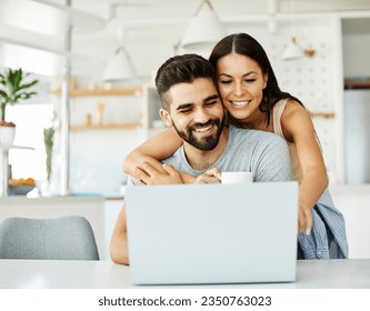 Portrait of a young happy smiling couple using laptop together at home. Wireless technology computer concept - Powered by Shutterstock