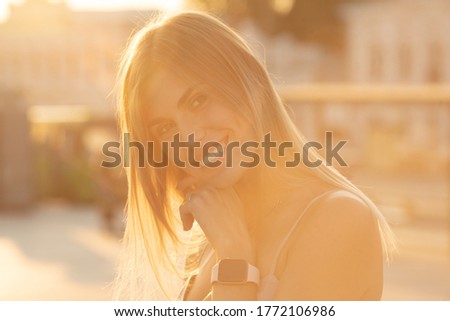 Similar – Woman with earphones listening music in smartphone