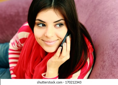 Portrait Of A Young Happy Thoughtful Woman Talking On The Phone And Looking Up