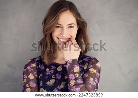 Portrait of young happy woman looking charming and smiling