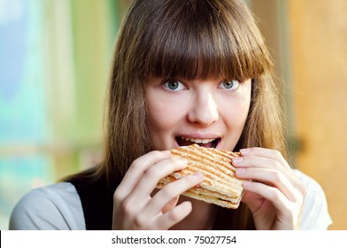 Portrait Of Young Happy Woman With Sandwich At Cafe