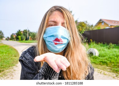 Portrait Young Happy Woman In Trendy Medical Face Mask Blowing Air Kiss With Hand. Beautiful Stylish Hipster Girl In Blue Protective Mask Send Blow Kiss.