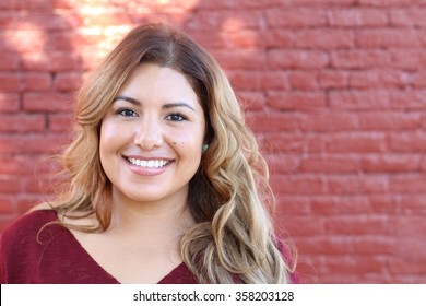 Portrait of a young Hispanic female smiling