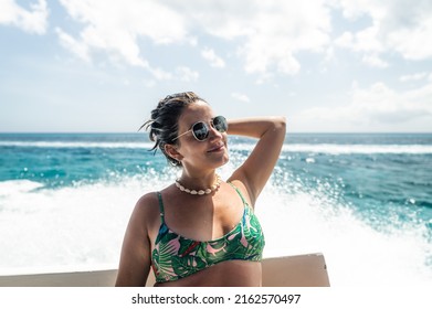 Portrait Of Young Hispanic Woman In Profile With Sunglasses On Boat