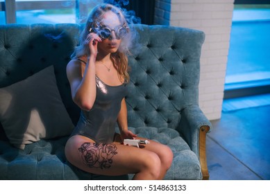 Portrait Of Young Hispanic Woman Smoking E-cig In Crazy Glasses