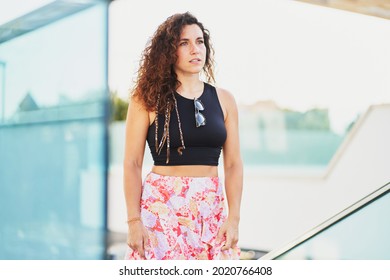 Portrait Of Young Hispanic Woman Walking Up Stairs