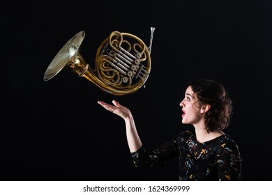 Portrait Of A Young Hornist Of A Philharmonic Orchestra With Her Instrument