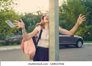 Portrait Of Young Inattentive Girl, Distracted By Mobile Phone. Girl Crashed Into Street Post, Dropped Phone.