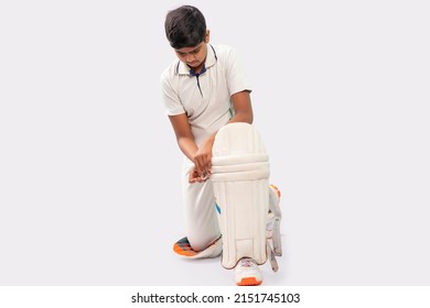 Portrait of young Indian boy wearing cricket pads and getting ready for Cricket game