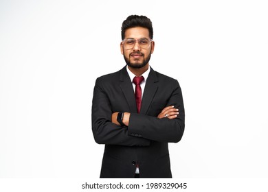 Portrait of young indian businessman with crossed arms on white isolated background.
