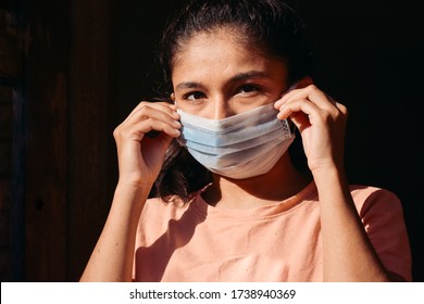Portrait Of A Young Indian Female Model Wearing Medical Mask Staring At The Camera