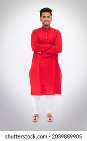 Portrait Of A Young Indian Man Standing Crossed Arms Against White Background