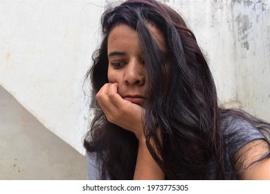 Portrait Of Young Indian Woman Sitting Alone Sad, Unhappy, Confuse, Depressed