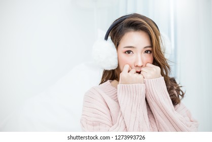 Portrait of young innocence asian woman relax in her bedroom. Smile happy face asian girl wear winter cloth. Beauty treatment perfect clear skin japanese makeup. Lifestyle cold winter hygge concept - Powered by Shutterstock