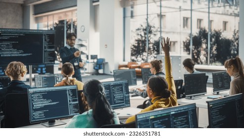 Portrait of a Young Inspired Black Female Student Studying in College with Diverse Classmates. African Girl Asking Teacher a Question. Girl Using Computer to Acquire IT Skills in Class - Powered by Shutterstock