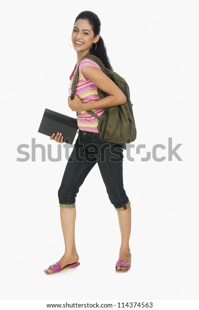 Portrait of a\
young lady carrying a bag and\
books