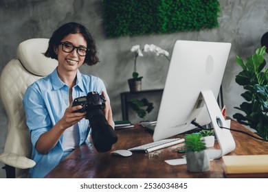 Portrait of young lady photographer casual style hold camera loft interior office studio indoors - Powered by Shutterstock