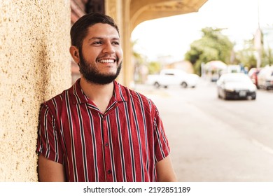 Portrait Of A Young Latin American Man Smiling Looking At Camera.