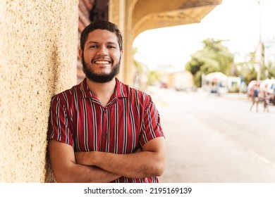 Portrait Of A Young Latin American Man Smiling Looking At Camera.