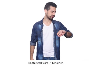 Portrait Of Young Latin Man Looking At His Watch. Isolated White Background.