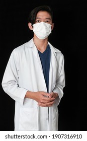 Portrait Of A Young Male Doctor On A Dark Background