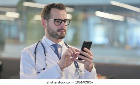 Portrait of Young Male Doctor using Smartphone - Powered by Shutterstock