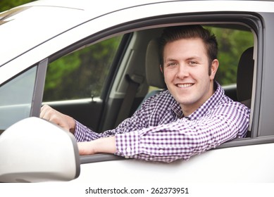 Portrait Of Young Male Driver Looking Out Of Car Window