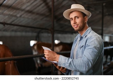 Portrait Of Young Male Farmer In Cowshed