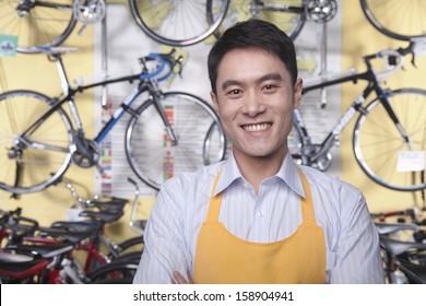 Portrait Of Young Male Mechanic In Bicycle Store